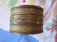 lovely vintage copper and brass cuff bracelet..1 1/2" wide..super pretty detail heavy weight bracelet Vintage Gold Bangle Made Of Copper, Vintage Bronze Copper Cuff Bracelet, Vintage Gold-colored Copper Bangle, Vintage Copper Bangle In Gold Color, Vintage Gold Copper Bangle, Bohemian Gold Cuff Bracelet In Copper, Bohemian Gold Copper Cuff Bracelet, Bohemian Gold Cuff Bracelet, Vintage Copper Bangle