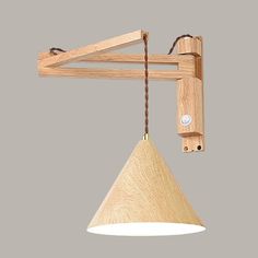 a wooden light fixture hanging from a ceiling with a cord attached to the lamp holder