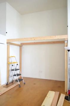 an unfinished room with ladders and construction materials