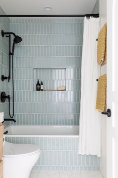 a white toilet sitting next to a bath tub