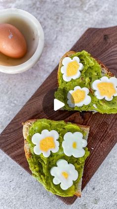 two pieces of bread with eggs on them and avocado sauce in the middle