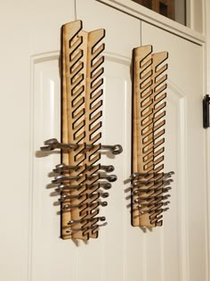 two wooden racks holding knives hang from the front door