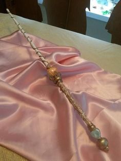 a pink cloth with a long metal handle on it