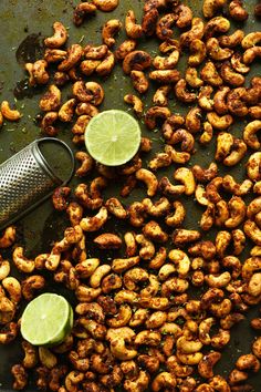 the cover of curry spiced cashews with lime slices and a strainer