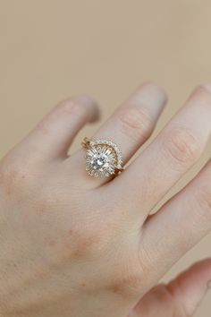 a woman's hand with a diamond ring on it