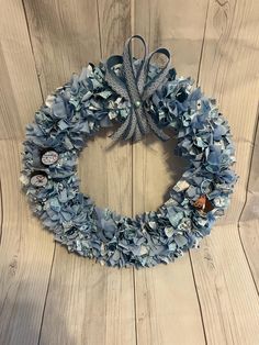 a blue wreath on a wooden wall