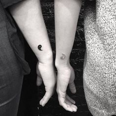 two people with matching tattoos on their arms