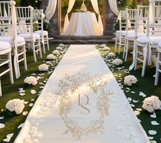 the aisle is decorated with white flowers and petals