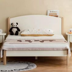 a small child's bed with a teddy bear on it