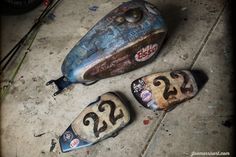 three shoes that have numbers painted on them sitting on the ground next to each other