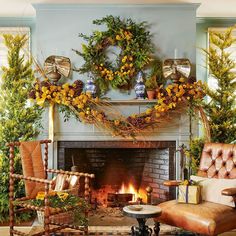 a living room decorated for christmas with wreaths on the fireplace