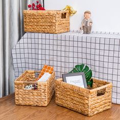 three wicker baskets sitting on top of a wooden table