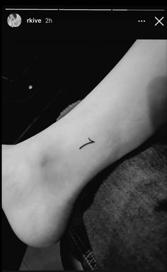 a black and white photo of a foot with a cross on it