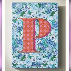 the letter p is made out of fabric and has flowers all over it, along with a purple border