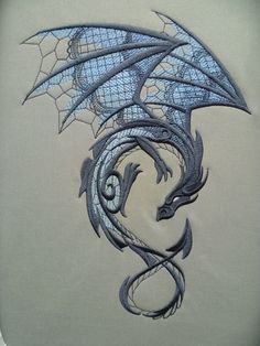 a drawing of a blue dragon on white paper