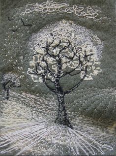 this is an image of a tree with white flowers in the middle and birds flying around it