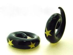 two black rings with yellow stars on them