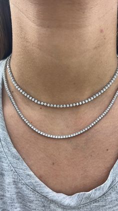 A classic tennis necklace for any occasion. The 2.0ct Diamond Tennis Choker features graduating diamonds that sit right against the neck. The perfect piece to start layering! Available in 14k Yellow Gold or White Gold 2.0ct total carat weight Necklace, 8.5" of diamonds with 6" of adjustable rings Diamond Color: G, Clarity: SI1 Pictured below layered with our Petite Diamond Tennis Necklace. Made to Order. Lead time is 2-4 weeks. Benefits of Solid 14k Gold Jewelry Most loved for its durability and Tennis Necklace Layered, Diamond Tennis Necklace, Rings Diamond, Tennis Necklace, Accessories Jewelry Earrings, Diamond Color, Lead Time, Adjustable Rings, Earring Necklace