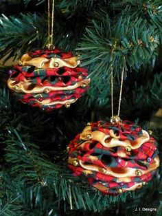 two ornaments hanging from a christmas tree