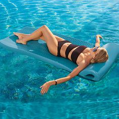 a woman laying on a surfboard in the water