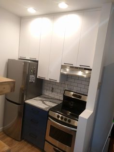 a kitchen with stainless steel appliances and white cabinets