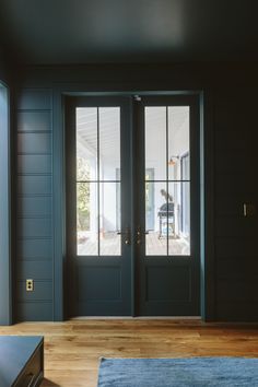 the interior of a house with double doors and wood flooring