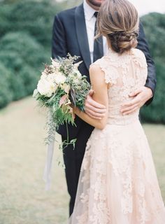 the bride and groom are embracing each other