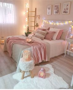 a bed room with a neatly made bed and lights