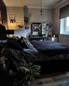 a bedroom with a large bed and lots of plants on the floor next to it