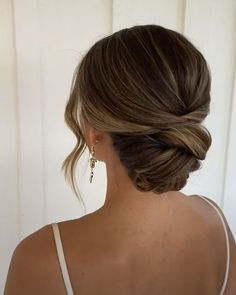 a woman with her hair in a low bun