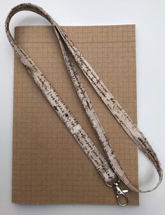 a white and brown dog leash sitting on top of a piece of paper