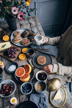 a person sitting at a table with food on it