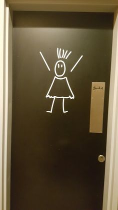 a black door with a drawing of a girl on it's front and side