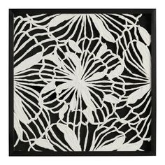 a black and white paper cutout with flowers on it's side, in the middle