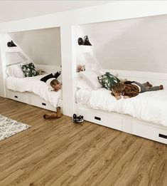 two children are laying on their beds in the same room, one is upside down