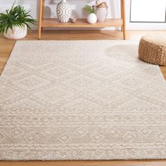 a beige rug on the floor in front of a wooden shelf and potted plant