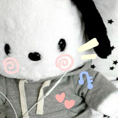 a stuffed animal wearing a hoodie with hearts and stars on it's chest