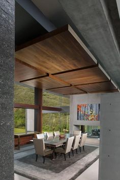 a dining room table and chairs in front of a large window