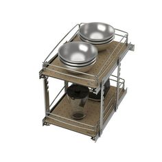 two bowls and pans are stacked on top of each other in a metal rack