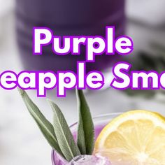 a purple apple smoothie in a glass with an orange slice on the rim and sage