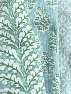 closeup of green and white fabric with different designs on it's sides, including leaves