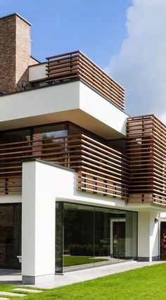 a modern house with wooden slats on the roof