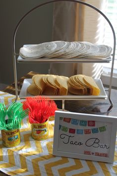 there is a tray with food on it next to a sign that says taco bar