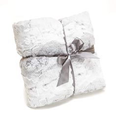 two white blankets wrapped in silver ribbon on top of each other with a gray bow