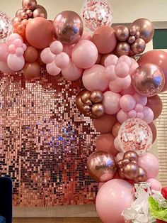 a laptop computer sitting on top of a table next to a bunch of balloons and confetti