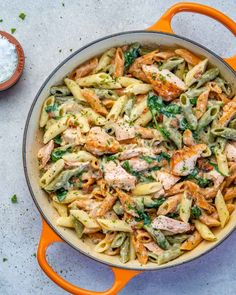 a skillet filled with pasta and chicken