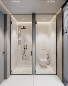 a bathroom with marble walls and flooring, two shower heads are on the wall