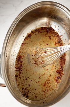 a person whisking something in a saucepan