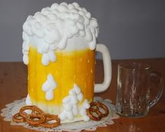 there is a cake made to look like a beer mug and pretzels on the table