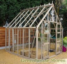 a small greenhouse in the middle of a yard